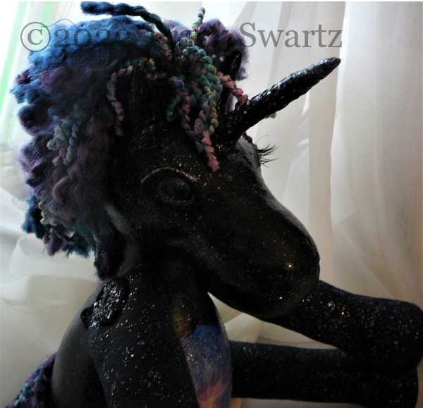  head shot of a dark unicorn made from gourds and mixed media with a scene from the Universe on it's belly